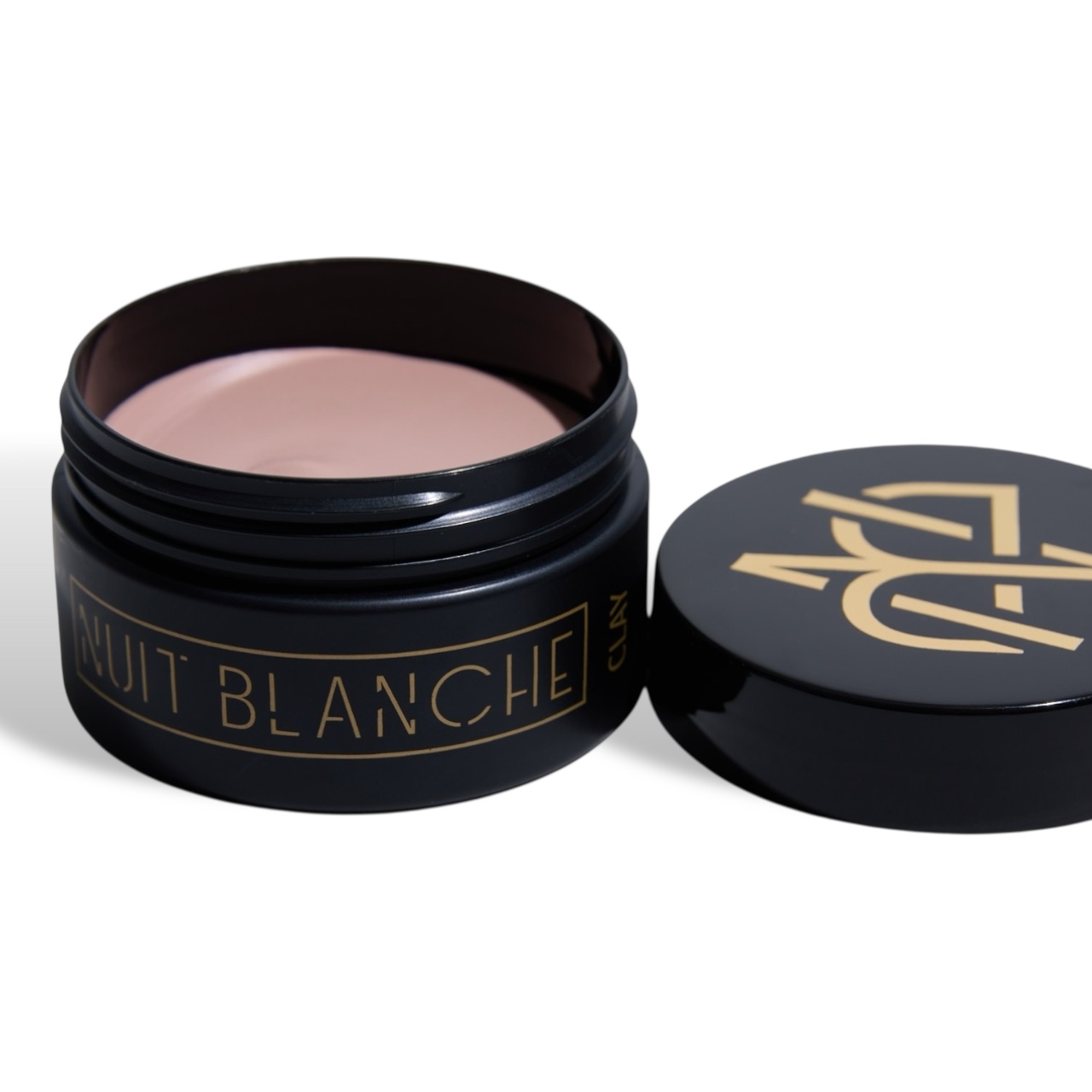 Nuit Blanche matte clay hair styling product in an open black jar with styling clay inside.